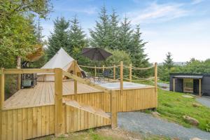 a wooden deck with an umbrella and a tent at 1 Bed in Austwick oc-r32793 in Eldroth