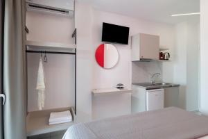 a small white room with a bed and a sink at Blue Horizon Sarti Chalkidiki in Sarti
