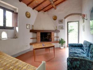 a living room with a couch and a fireplace at Farmhouse in Castelfranco Piandiscò with Garden in Castelfranco Piandisco