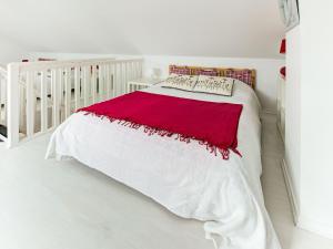 a white bed with a red blanket on it at Harbor Haven in Isigny-sur-Mer in Isigny-sur-Mer +32 photos