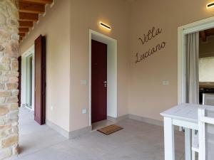 a hallway of a house with a red door at Idyllic cottage next to the beautiful Lake Idro in Crone