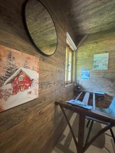 a room with a wooden wall with a table and a mirror at La Chotte du Musher in Champéry +19 photos