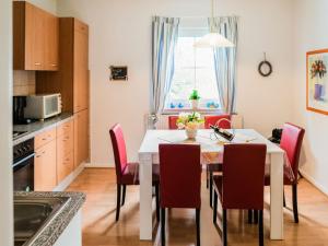 a kitchen and dining room with a table and chairs at Luxurious Apartment in Medebach near public pool in Medebach
