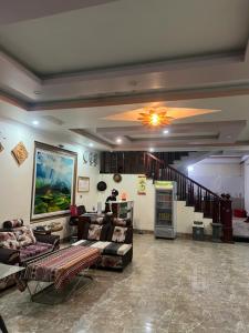 a large living room with couches and a staircase at Amlysa Sapa Hotel 2 in Sa Pa