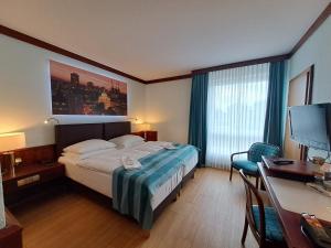 a hotel room with a bed and a desk and a desk at Leine Hotel in Pattensen