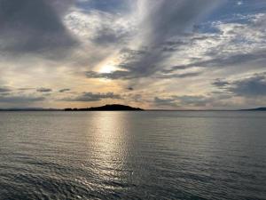 a large body of water with a cloudy sky at Nice apartment in Tuoro sul Trasimeno with pool in Tuoro sul Trasimeno