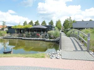 a bridge over a body of water with a building at Lovely Holiday Home in Kattendijke near Centre in Kattendijke