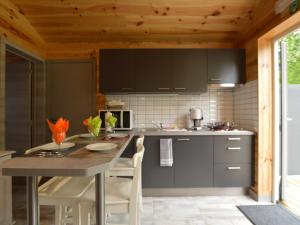 a kitchen with a table and chairs in a room at Scenic chalet in Vieuxville with terrace in Vieuxville