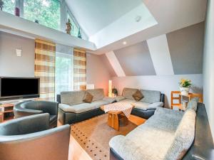 a living room with couches and a flat screen tv at Deluxe Holiday Home in Brilon-Wald near Ski Area in Brilon