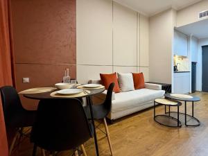 a living room with a couch and a table and chairs at Siena Suite Tsaghkadzor in Tsaghkadzor
