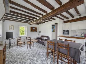 a living room with a table and chairs at Cozy Normandy Escape in Aignerville