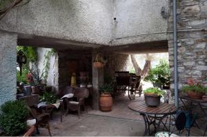 an outdoor patio with tables and chairs and a piano at Al Museo in Ponte