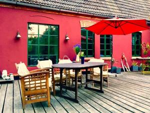 a wooden deck with a table and chairs and an umbrella at Gorgeous apartment in Neuburg with terrace in Neuburg-Steinhausen