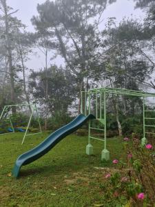 a playground with a slide in a park at Casa Manta Mountain home, pool, bonfire, camping in Ablayan