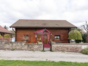 a small house with a red door on a stone wall at Nature Chalet in Abbévillers in Abbévillers +32 photos