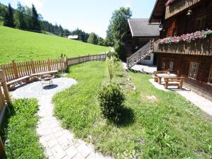 a garden with a bench and a wooden building at Sprawling Mansion near Ski Area in Salzburg in Eben im Pongau