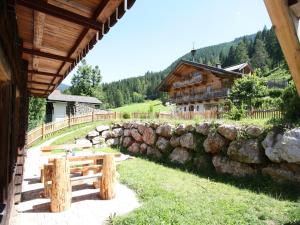 a building with a stone wall next to a house at Sprawling Mansion near Ski Area in Salzburg in Eben im Pongau