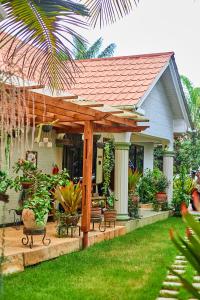a house with a wooden pergola in the yard at Lavish Luxury Homes in Tengeru