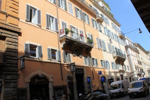a tall building with cars parked in front of it at 504 Corso Suites in Rome