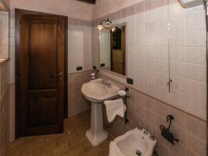 a bathroom with a sink and a toilet and a mirror at Elegant apartment only 1 hour from Rome in Narni