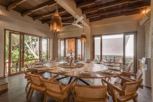 a large dining room with a large table and chairs at Layla Cabana - 7BR Villa in Pererenan - With Private Pool, Spa, Cinema & Gym in Tumbak Bayuh