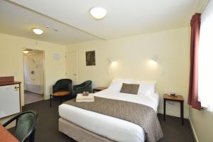 Ένα ή περισσότερα κρεβάτια σε δωμάτιο στο Bella Vista Motel Gisborne