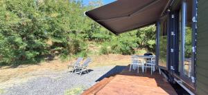 a patio with chairs and a table on a house at Tiny Badacsony in Badacsonytomaj