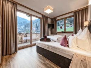 a bedroom with a large bed with a large window at Farmhouse in Schwendau with Ski Storage in Hippach