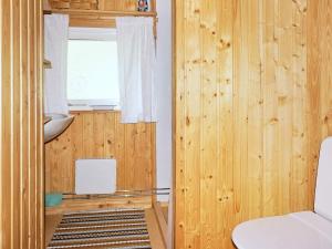 a room with wood paneled walls and a window at 4 person holiday home in Vetlanda in Lillarp +7 photos