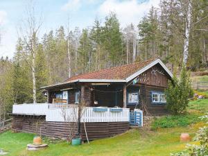 a log cabin in the middle of a forest at 4 person holiday home in VETLANDA in Lillarp