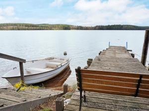 a boat is docked at a dock on a lake at 4 person holiday home in VETLANDA in Lillarp