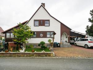 a house with a car parked in front of it at Peaceful Apartment in Lichtenhain with Private Terrace in Lichtenhain