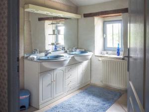 a bathroom with two sinks and a window at Holiday Home in Saint-Laurent-de-la-Salle with Pool in La Chapelle-Thémer +28 photos