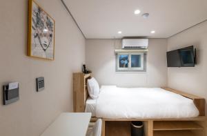 a small room with a bed and a tv at Hi Seodaemun in Seoul