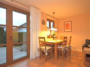 a dining room with a table and chairs and a window at Cosy apartment with private garden in Brachthausen in the Sauerland in Brachthausen
