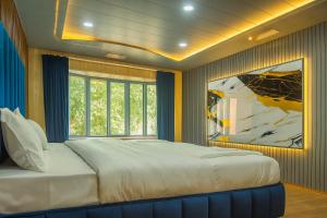 a bedroom with a large bed and a painting on the wall at The solace pahalgam in Pahalgām