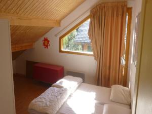 a small bedroom with a bed and a window at Chalet in Saint-Jean near Ski Lift in Saint-Jean-d'Aulps