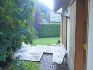 a garden with a wooden bench in a yard at Chalet in Saint-Jean near Ski Lift in Saint-Jean-d'Aulps