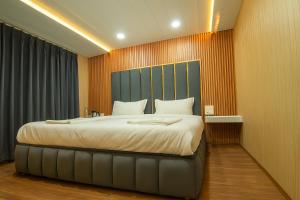 a bedroom with a large bed with a blue headboard at The solace pahalgam in Pahalgām