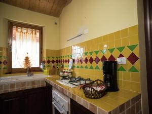 a kitchen with a sink and a stove top oven at Holiday Home in Paciano with Swimming Pool,Terrace,Billiards in Paciano