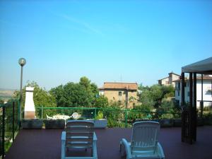 two blue chairs and a table on a patio at Holiday Home in Paciano with Swimming Pool,Terrace,Billiards in Paciano +14 photos