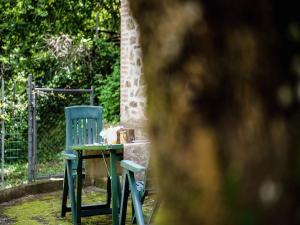 a table and a blue chair in a yard at Holiday Home in Paciano with Swimming Pool,Terrace,Billiards in Paciano