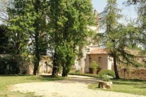 a house with trees in front of a building at Saint-Paul Pool Retreat in Saint-Paul-du-Bois