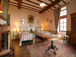 a bedroom with two beds and a table in it at Saint-Paul Pool Retreat in Saint-Paul-du-Bois