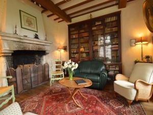 a living room with a couch and a fireplace at Saint-Paul Pool Retreat in Saint-Paul-du-Bois +32 photos
