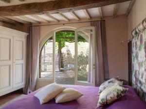 a bedroom with a bed with pillows and a window at Ritzy Villa on a Wine Estate in Arezzo with Pool in Arezzo +31 photos