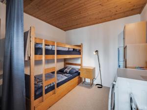 a bedroom with two bunk beds and a desk at Beautiful holiday home in Viechtach with views in Viechtach +12 photos