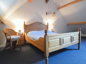 a bedroom with a bed and a table and a chair at Holiday Home in Geesteren with Roof Terrace,Garden Furniture in Geesteren