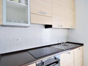 una cucina con mobili in legno e un lavello di Simplistic apartment in Dervio with balcony terrace a Dervio Altre 56 foto