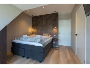 a bedroom with a large bed in a room at Appealing apartment in Domburg near the beach in Domburg